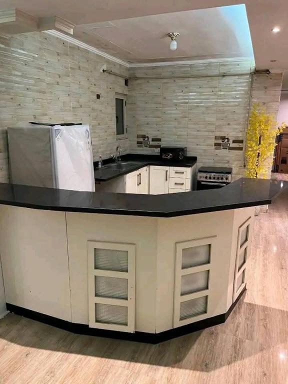 a kitchen with a large counter top in a room at Vrtn hotel in Amman