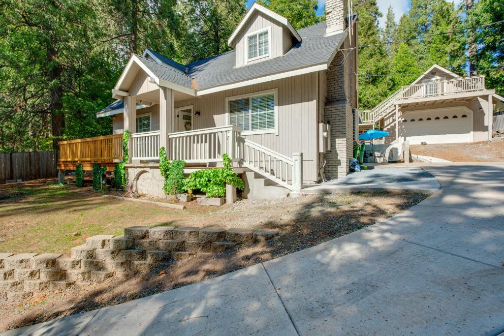 a house with a porch and a driveway at Hot Tub and Game Room Luxe Cabin, Day Trip to Tahoe in Pollock Pines