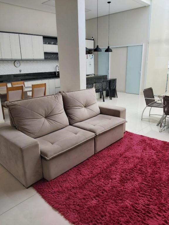 a living room with a couch and a red rug at Home of happiness in Monte Sião