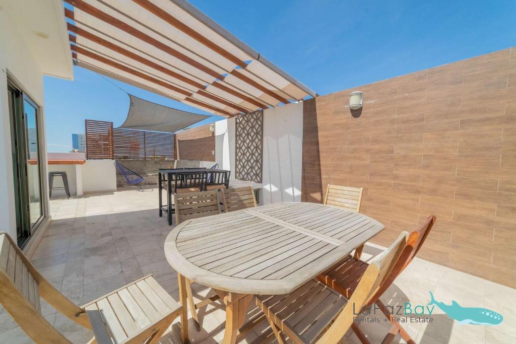a wooden table and chairs on a patio at Brand New Townhome with Private Rooftop in La Paz