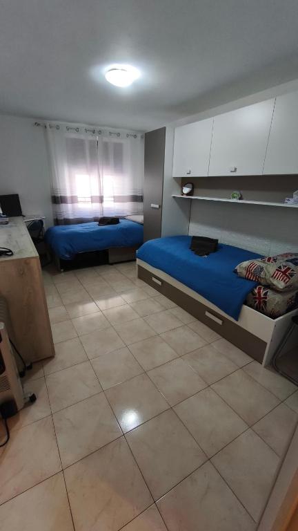 a room with two beds in a room with a kitchen at Nido del Melo in Cles