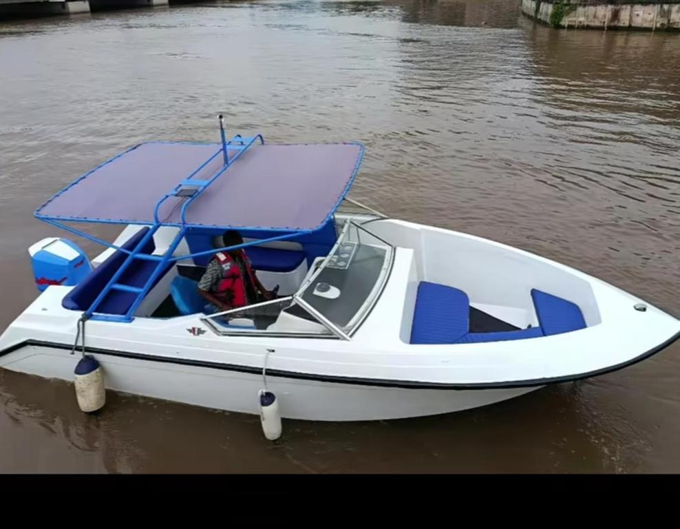 a white and blue boat in the water at Richesther cruise world in Lagos