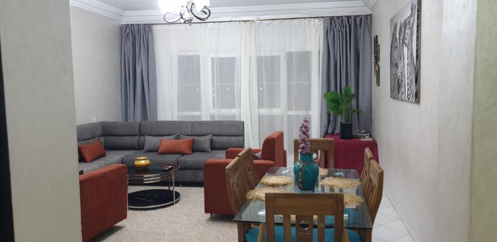 a living room with a couch and a table at Beach apartment down town in Agadir
