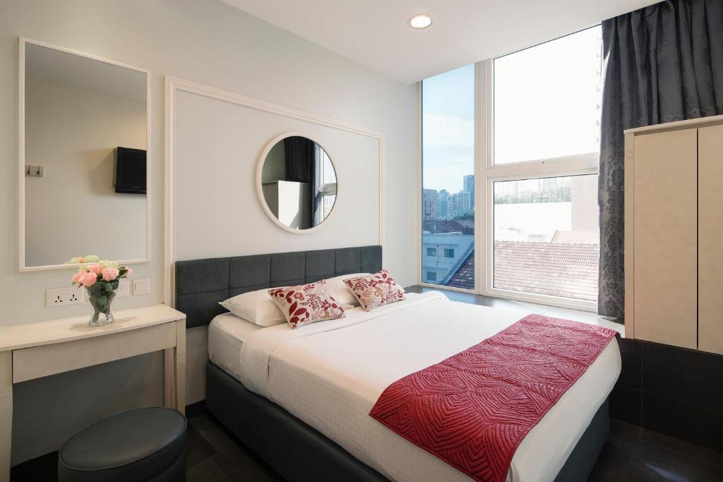 Postel nebo postele na pokoji v ubytování Value Hotel Balestier