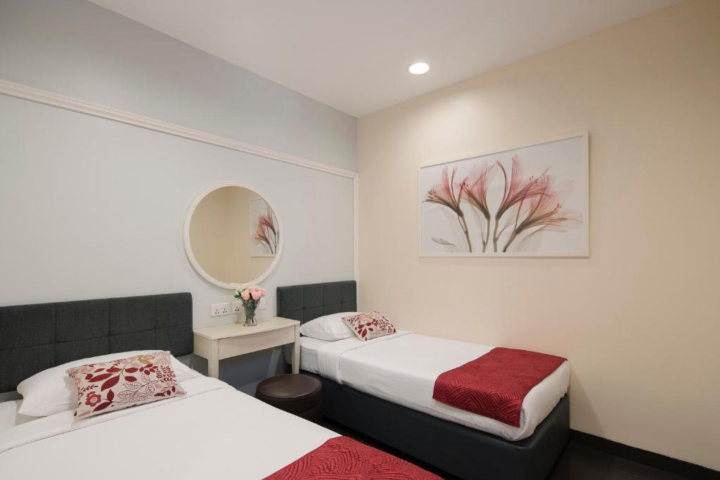 Postel nebo postele na pokoji v ubytování Value Hotel Balestier