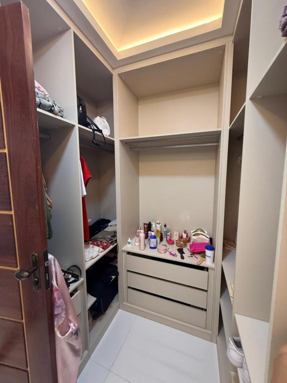 a walk in closet with white walls and white floors at Triplex Belém in Belém