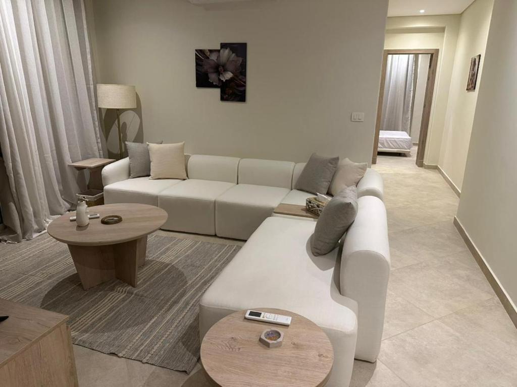 a living room with a white couch and a table at Mozaik Condotel in Cairo