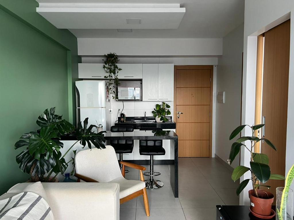 a kitchen with white appliances and plants in a room at Complet apartment with air conditioning in Belém
