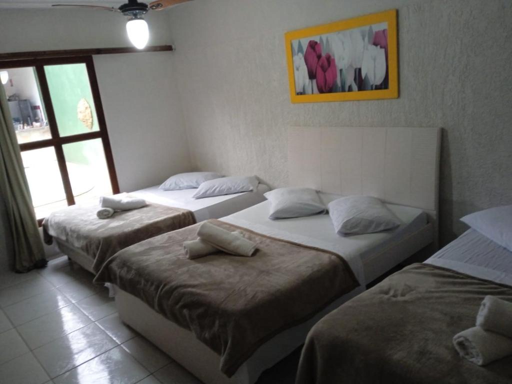 En eller flere senge i et værelse på Light House Pousada