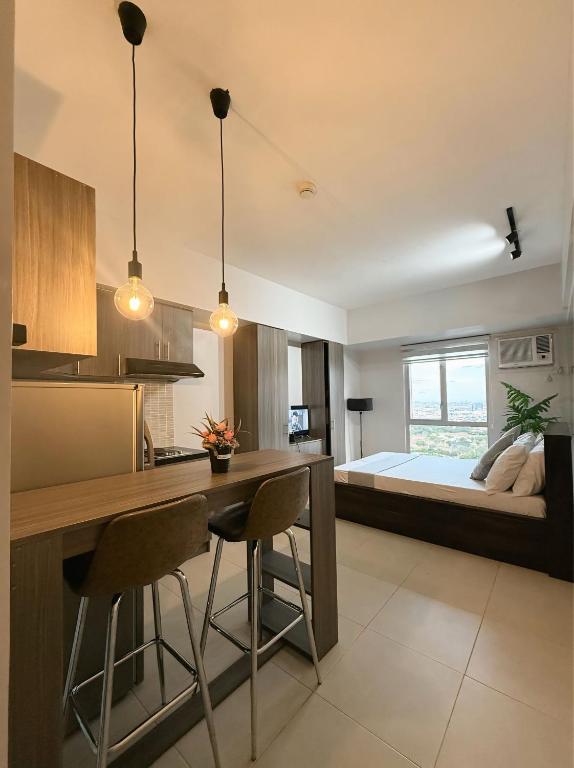 a kitchen and living room with a bed in the background at Lovely CondoStay Cebu T2-25 in Cebu City