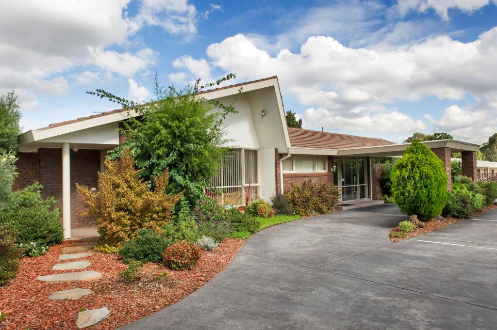 a house with a driveway in front of it at Box Hill Motel in Burwood