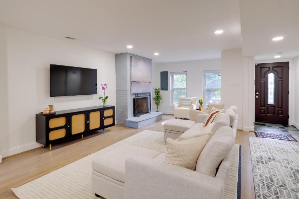 a living room with white furniture and a flat screen tv at Central DC Location! Urban Oasis in Logan Circle in Washington