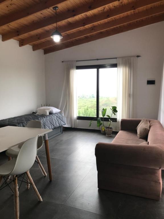 a living room with a bed and a couch at Agave Serrano in Villa Rumipal