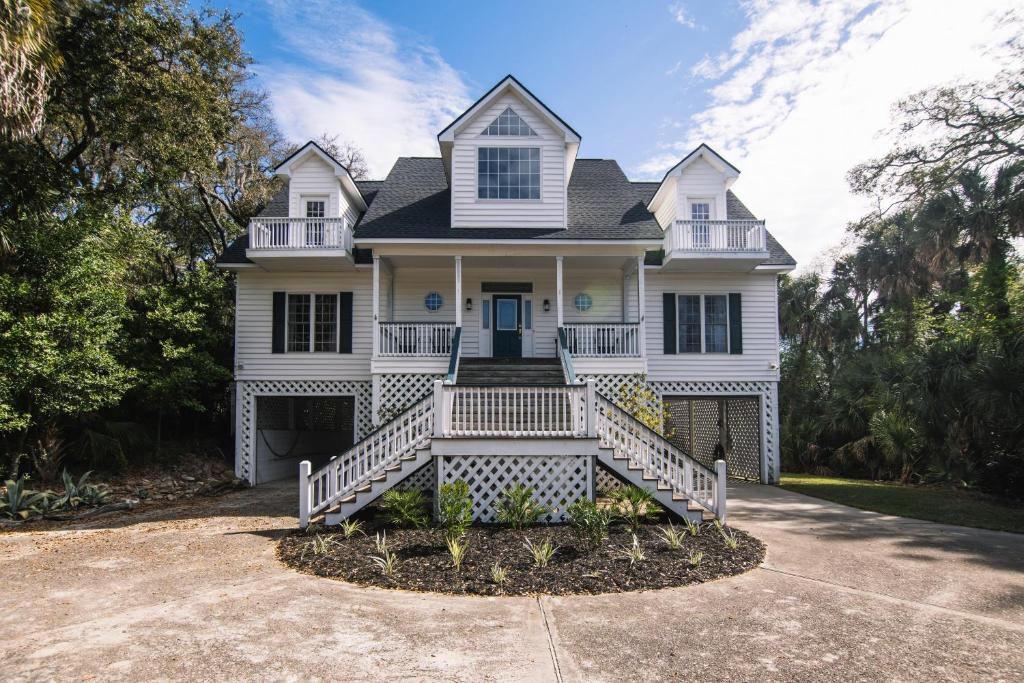 a white house with a large front porch at Indigo San' in Edisto Island
