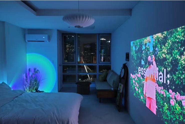 a bedroom with a bed and a large tv at 슈기스테이 in Seoul
