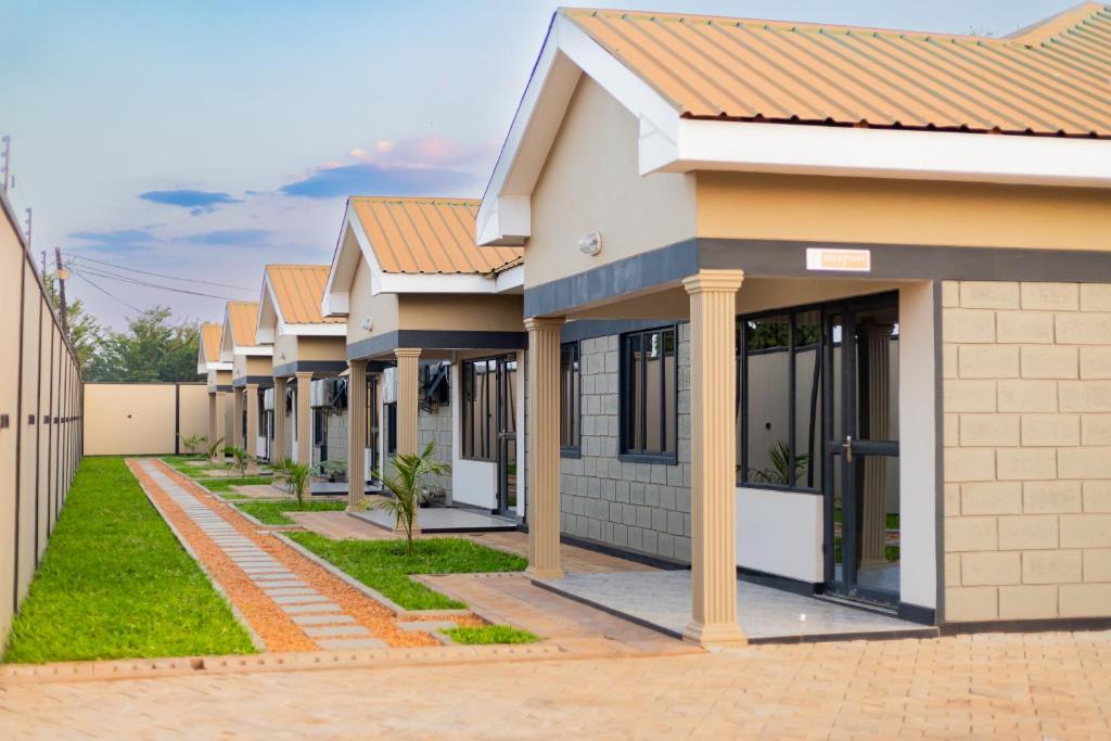 a row of houses on a street at Palms & Pebbles Lodge in Lilongwe