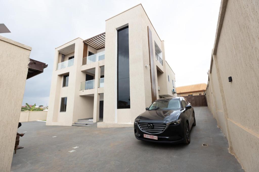 a black car parked in front of a building at The Riverdale, Kumasi in Kumasi