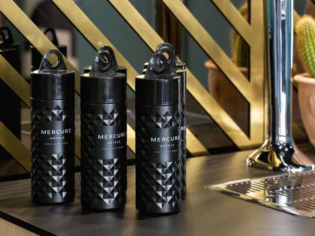 three black batteries sitting on top of a table at Mercure Paris Saint-Ouen in Saint-Ouen