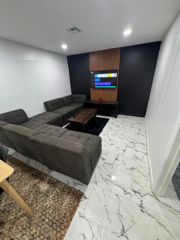 a living room with a couch and a flat screen tv at Apartment near by NYC, EWR and Met Life in East Orange