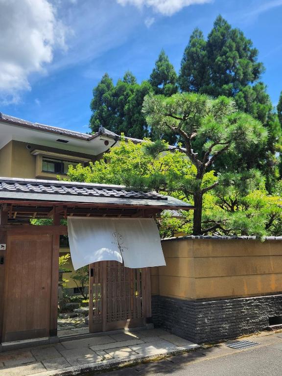 a building with a white curtain over the door at 嵐月-嵐山景區內獨棟別墅 in Kyoto