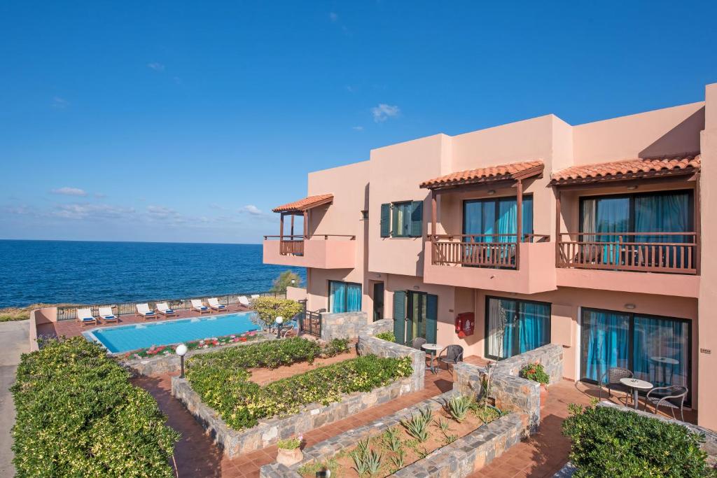an image of a building with the ocean in the background at Koutrakis Suites by Estia in Sisi