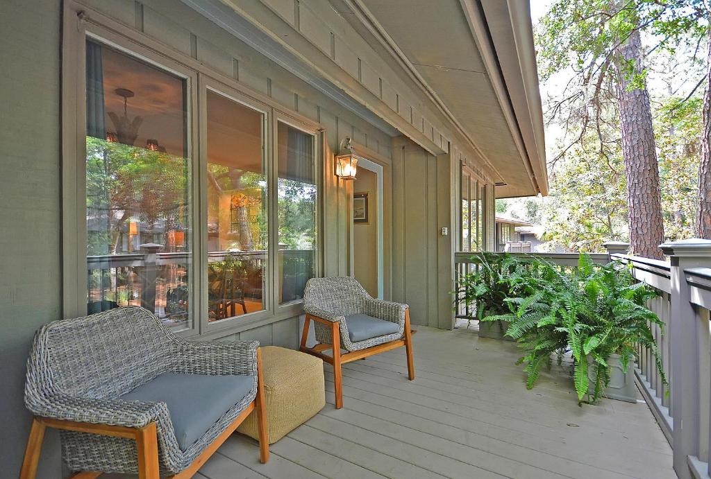 a porch of a house with chairs and windows at IC106: 106 Inlet Cove in Kiawah Island