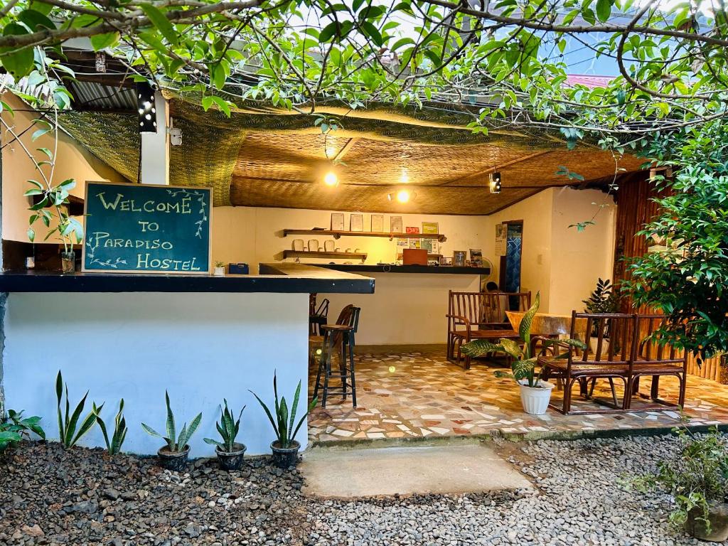 a patio with a bar and a restaurant at Paradiso Hostel El nido in El Nido
