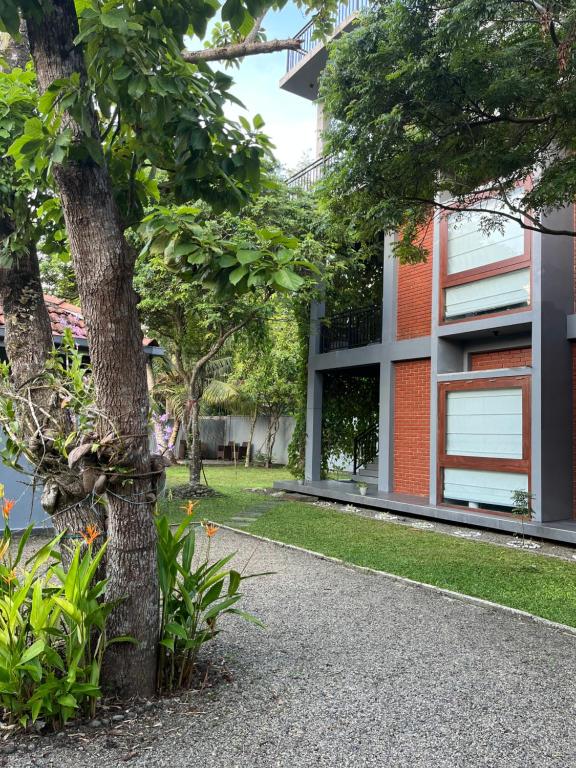 a tree in front of a building at Coastal Hideaway in Midigama