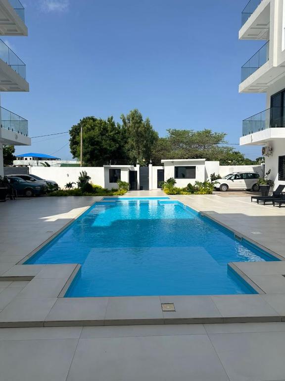 a large blue swimming pool in a parking lot at The Heights in Bijilo