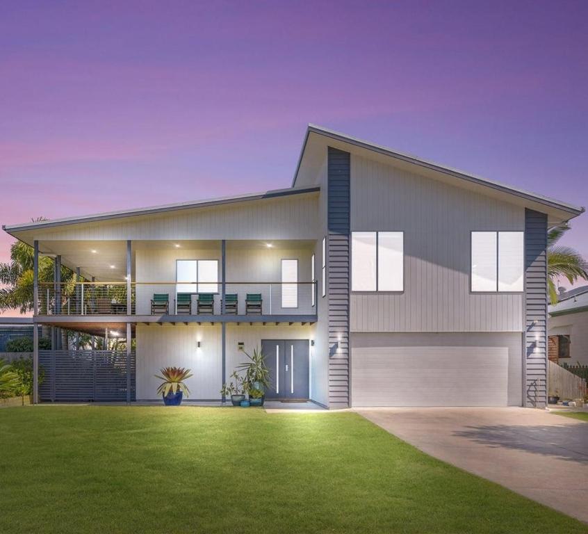a rendering of a house with a green lawn at The Lazy Tide in Burrum Heads