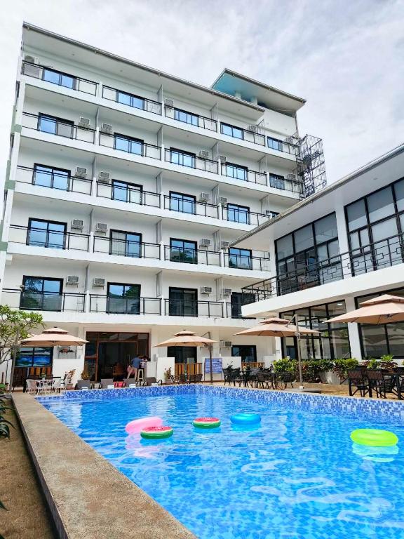a large building with a swimming pool with frisbees in it at Ocean Star Hotel Coron in Coron