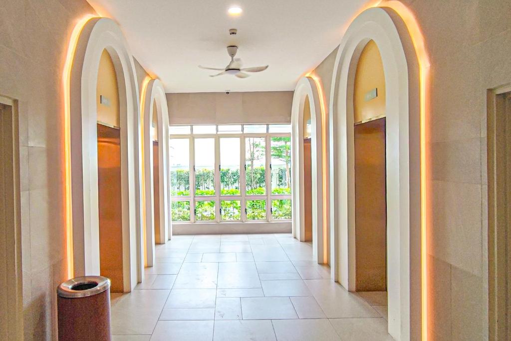 an empty hallway with arches and a large window at Peaceful Luxury at Tresor Klang by HCK in Petaling Jaya
