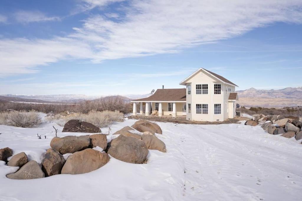 a house in the snow with rocks in front of it at Lone Eagle Haven home in Mesa