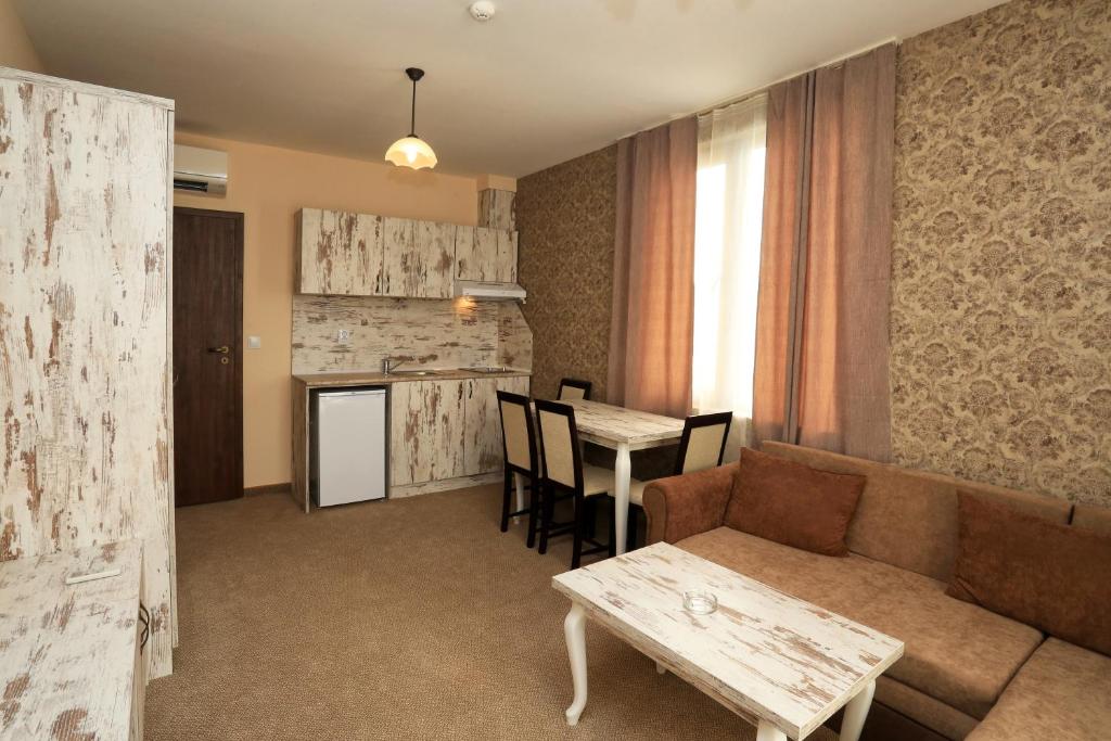 a living room with a couch and a table at Paraiso Theopolis - All Inclusive in Obzor