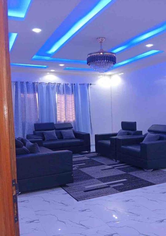 a living room with couches and a blue ceiling at 2chambres salon villa Thierno sene in Niakoul Rap