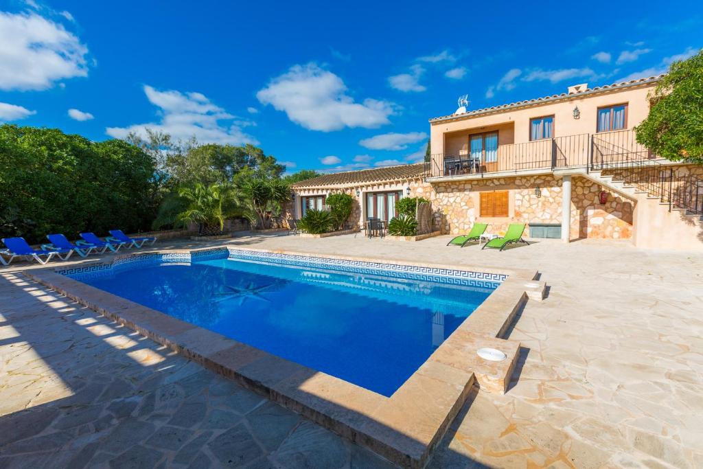 a villa with a swimming pool and a house at Can Fus in Campos