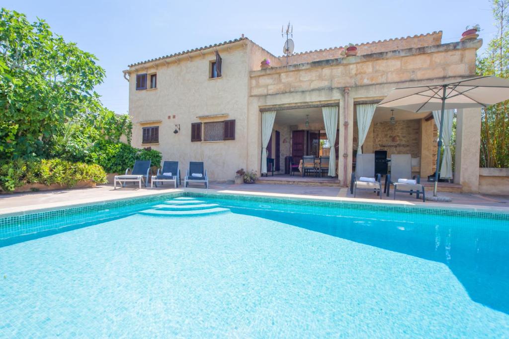 a villa with a swimming pool and a house at Son Gorrió in Sant Llorenç des Cardassar