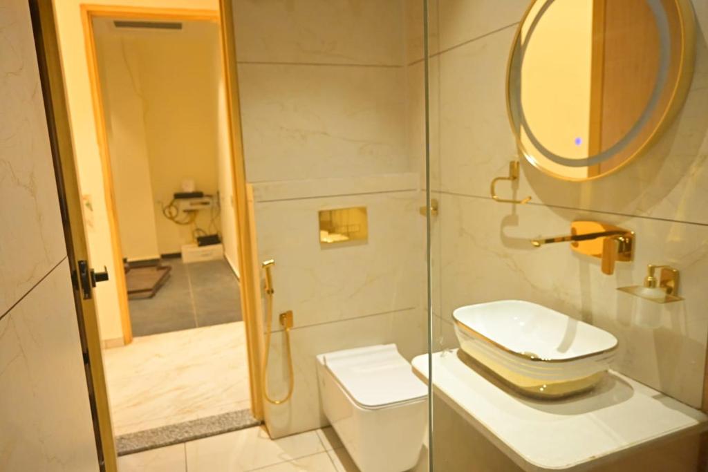 a bathroom with a toilet and a mirror at Shree shyam hotel & restaurant in Mahendragarh