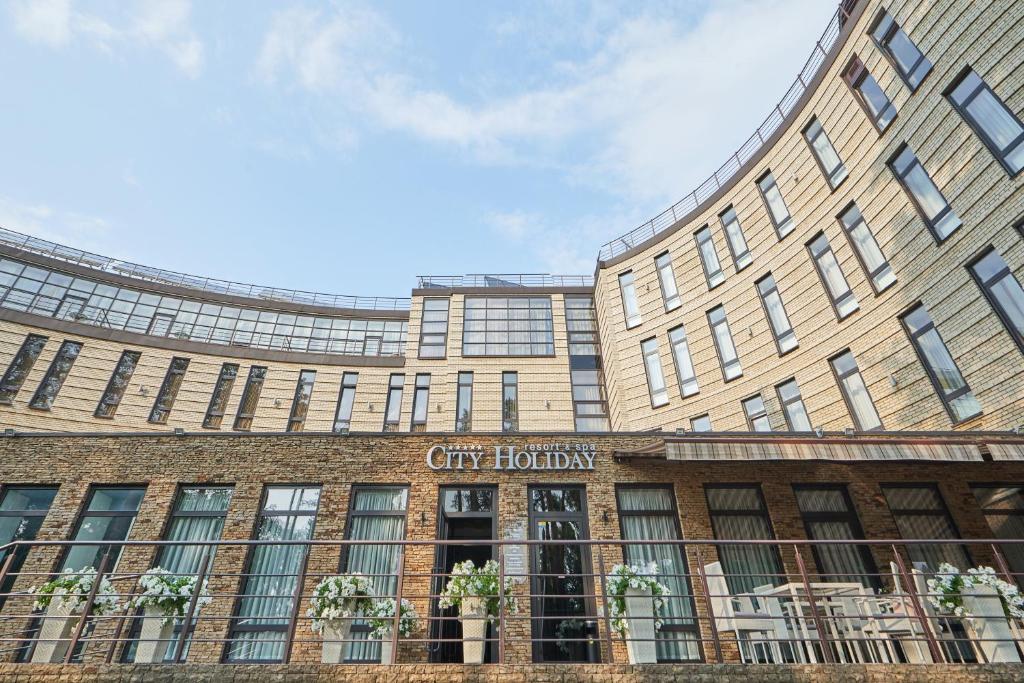 a large building with a sign on the front of it at City Holiday Resort & SPA in Kyiv
