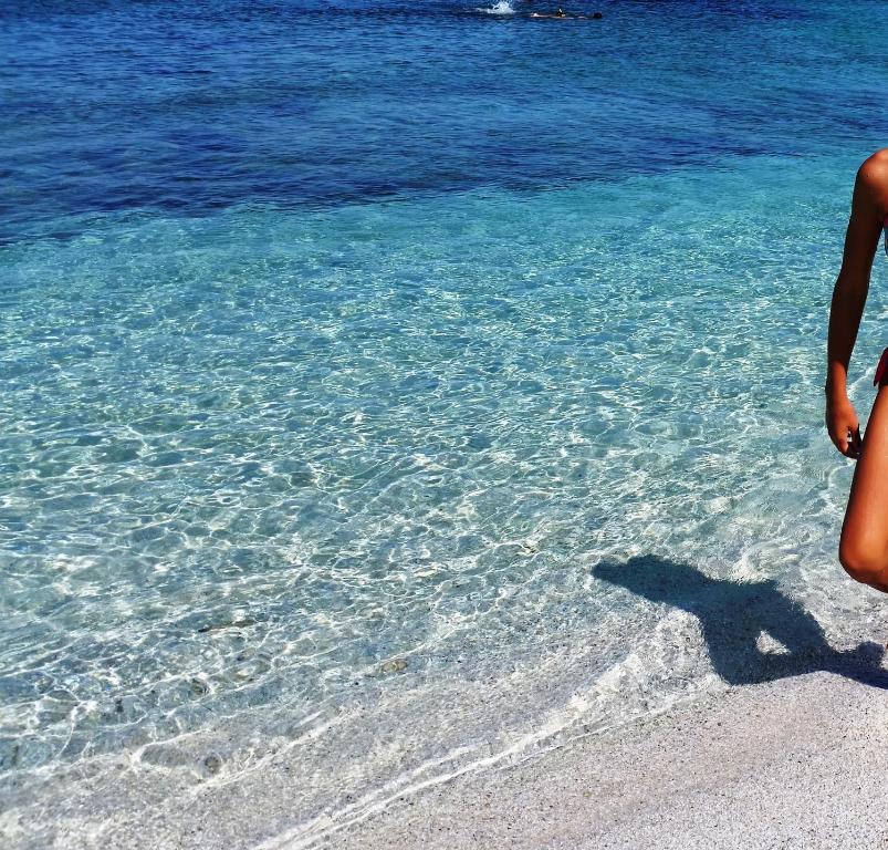 a shadow of a person standing on the beach at Casa degli Oleandri in Santa Caterina