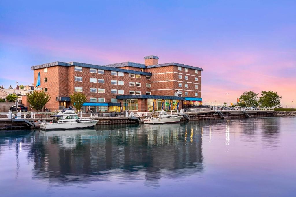 a building with boats docked at a marina at The Harborview on Lake Michigan, Ascend Hotel Collection in Port Washington