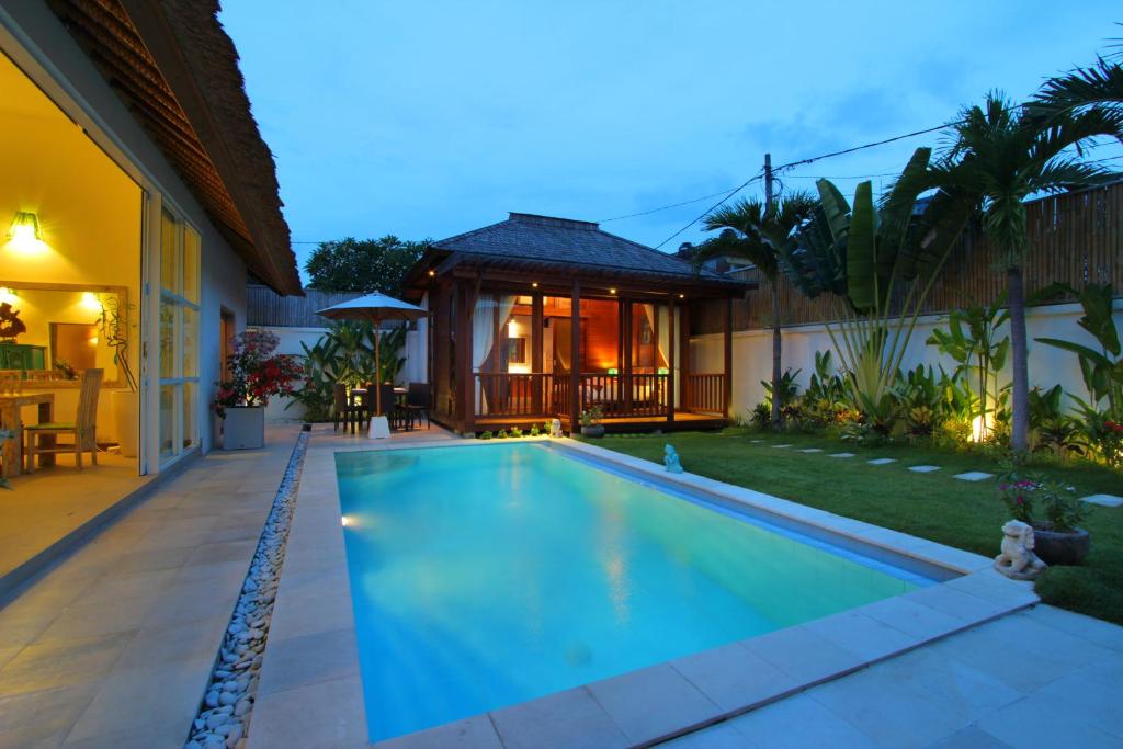 a swimming pool in the backyard of a house at Villa Blue Pearl by Optimum Bali Villas in Seminyak