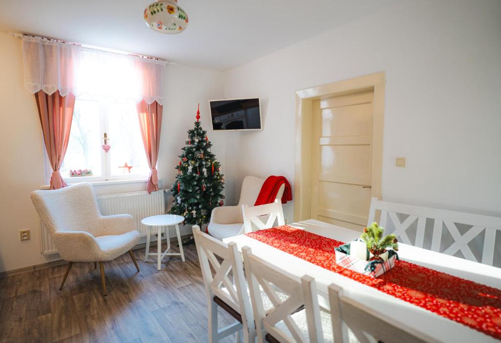 a living room with a christmas tree and a table at CHalupa Relax in Dolní Lomná
