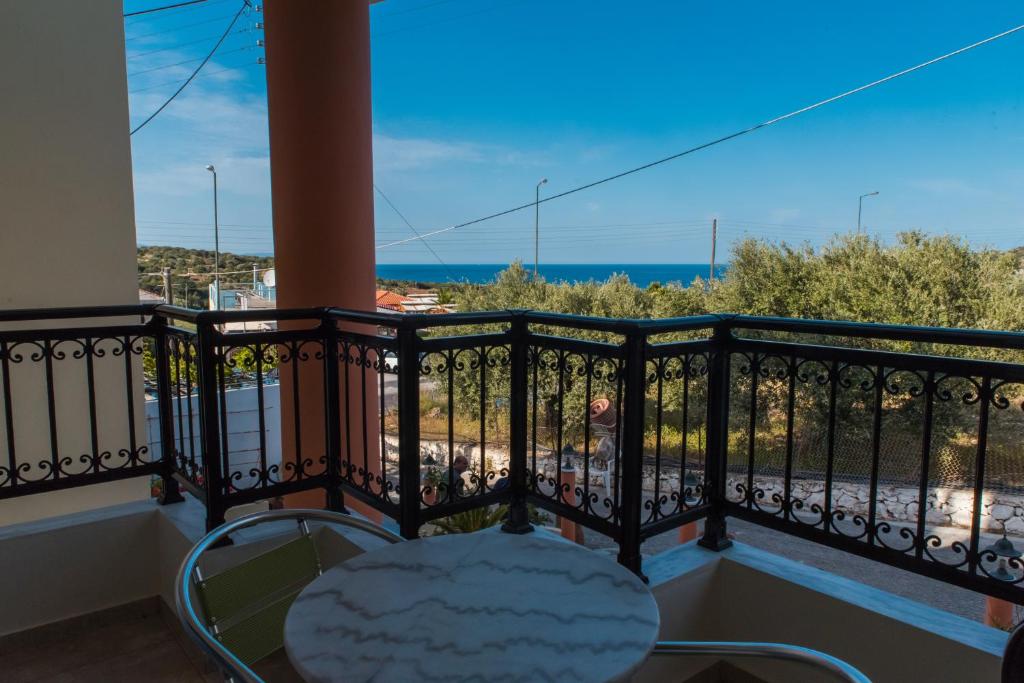 a balcony with a table and a view of the ocean at Vrokastro Apartments in Istro