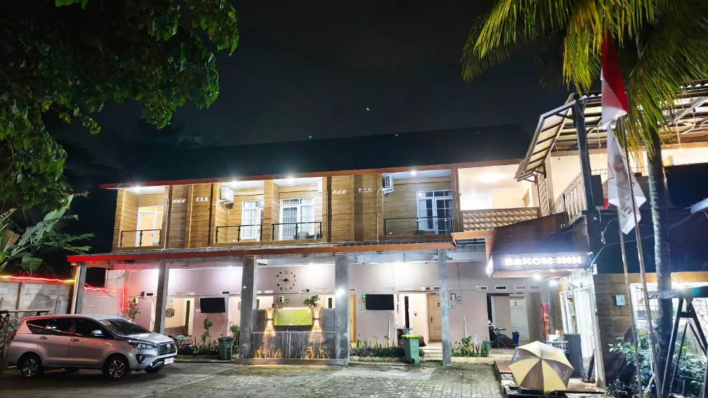 a car parked in front of a building at night at Bakom Inn Syariah in Bogor