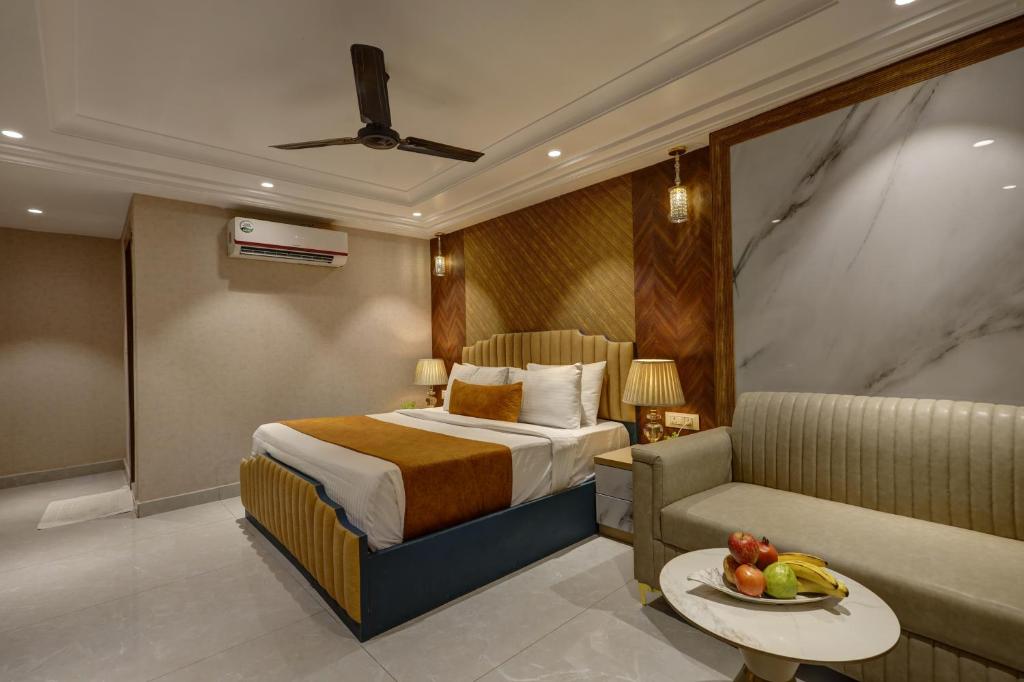 a hotel room with a bed and a couch at Hotel Deluxe Stay Inn Delhi Airport in New Delhi
