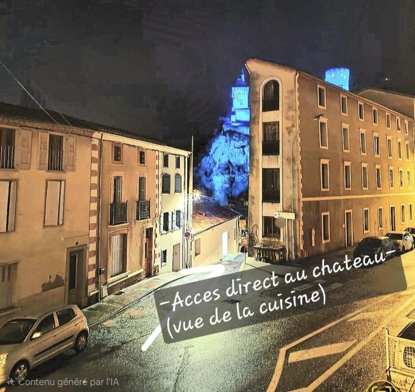 a sign on a city street with a clock tower at Spacieux 120 m2 en 3 chambres centre Foix - 2 sdb et 2 wc - Parking gratuit à 1 Minute in Foix