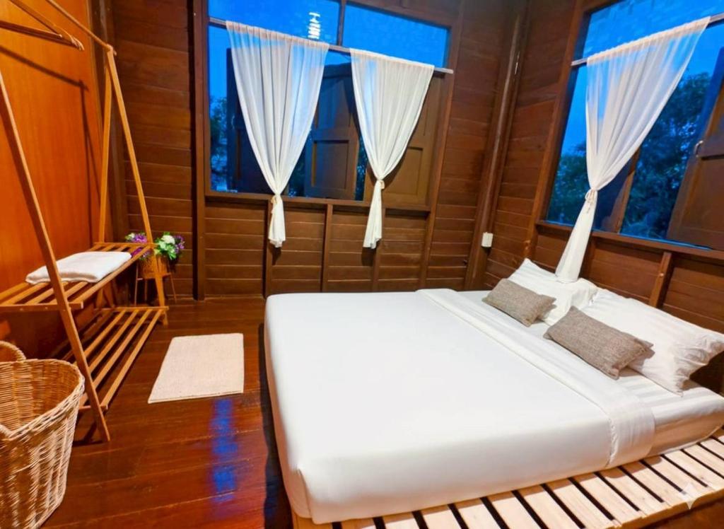 a bedroom with a bed and a swing at BaanBaimai Homestay in Chiang Rai