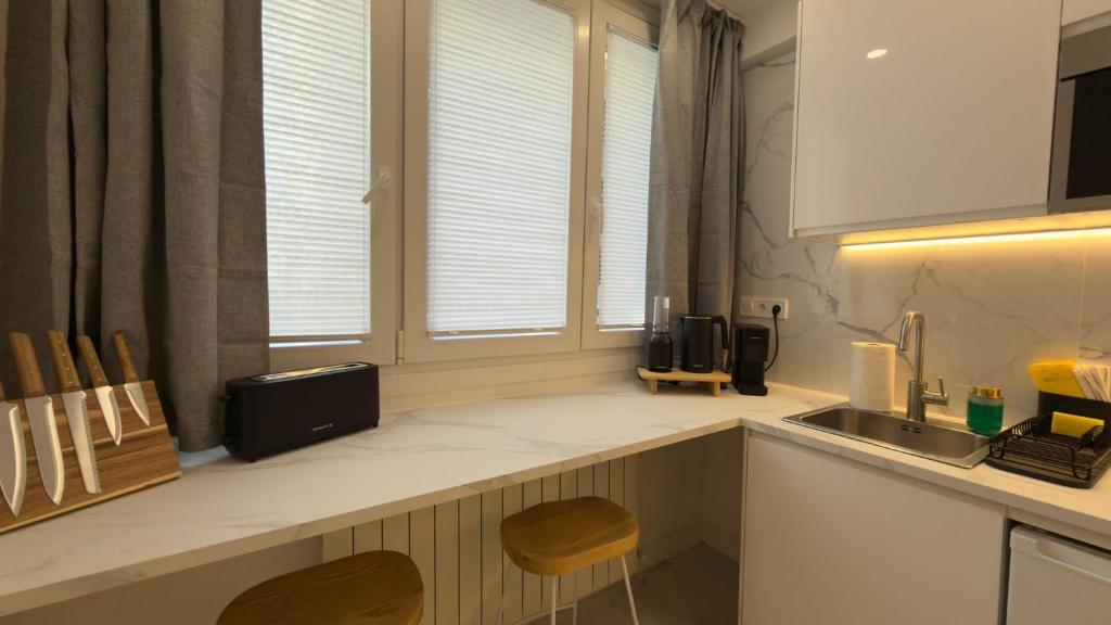 a kitchen with a sink and a counter with a counter at Viana apartaments in Bilbao