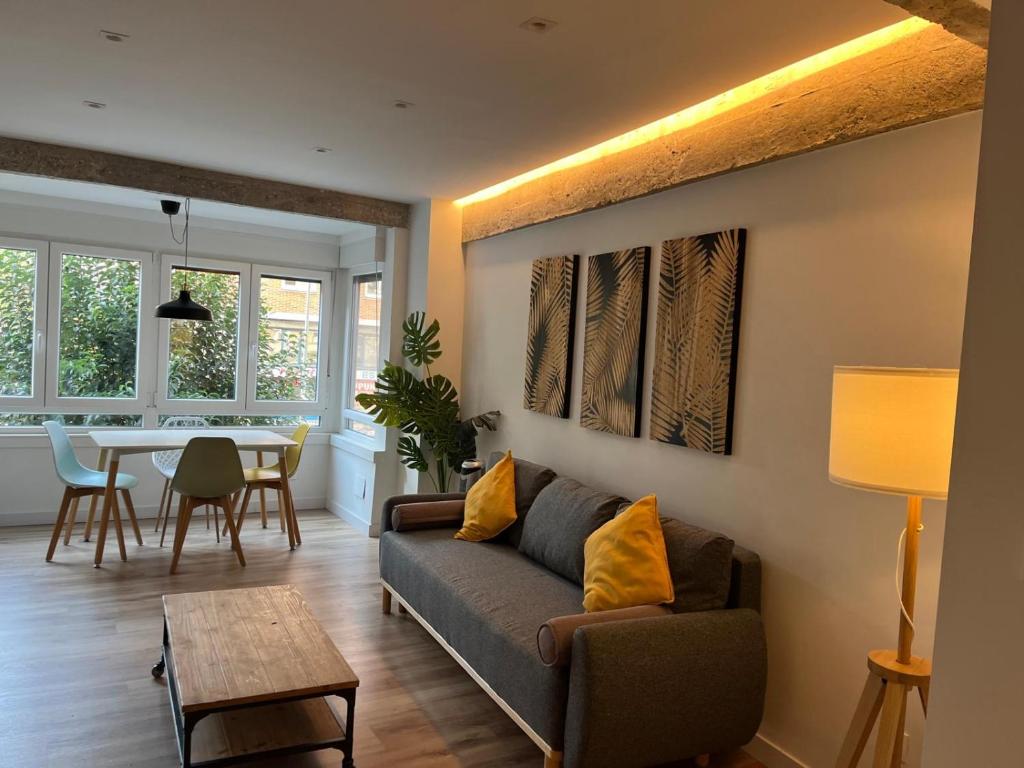a living room with a couch and a table at Modern apartment self check in bilbao center in Bilbao